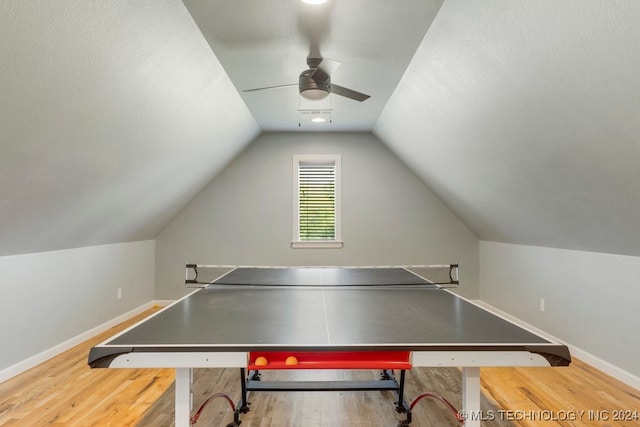 game room with vaulted ceiling, hardwood / wood-style flooring, and ceiling fan