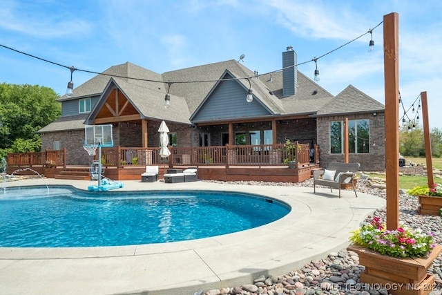 view of swimming pool with a deck and a patio