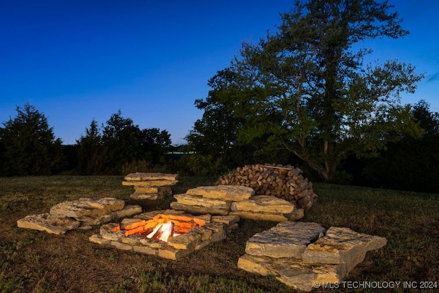 yard at dusk with a fire pit