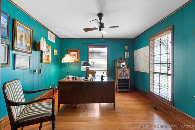 home office featuring crown molding, hardwood / wood-style floors, and ceiling fan