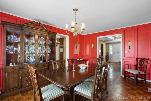 dining room featuring dark parquet flooring and a chandelier