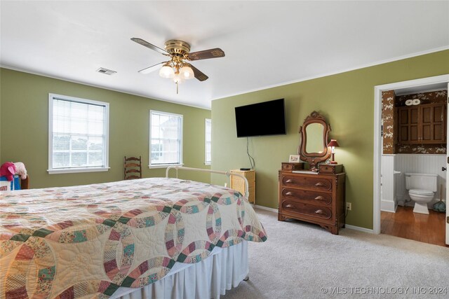 bedroom with connected bathroom, ceiling fan, and carpet floors