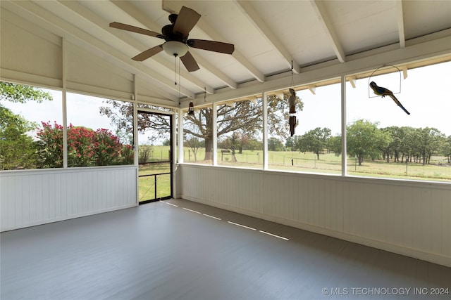 unfurnished sunroom featuring vaulted ceiling with beams and ceiling fan