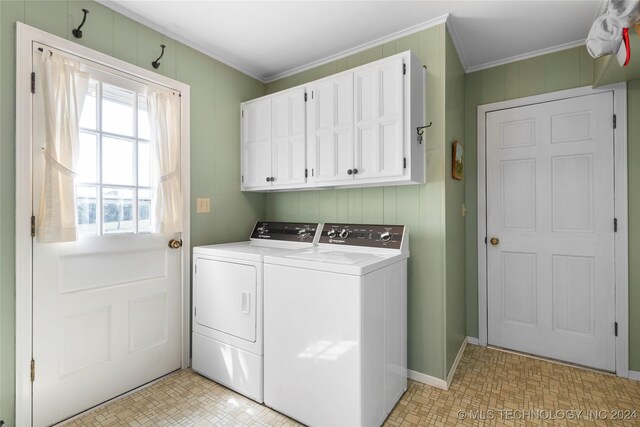 laundry room with cabinets, ornamental molding, and separate washer and dryer