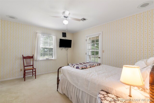 bedroom with ceiling fan and light colored carpet