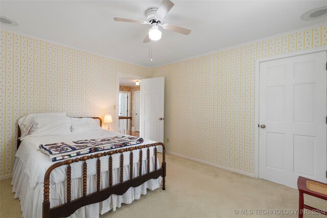 bedroom featuring light carpet and ceiling fan