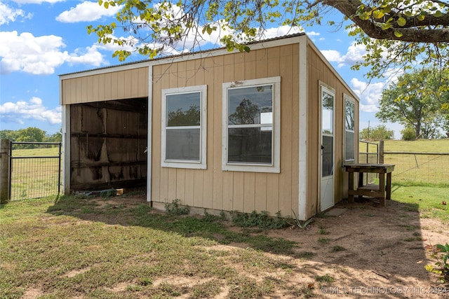 view of outbuilding with a yard