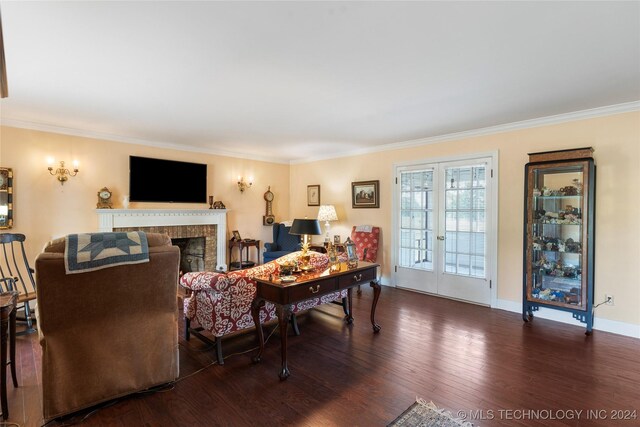 living room featuring ornamental molding, a brick fireplace, dark hardwood / wood-style floors, and french doors