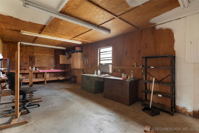 interior space with wood walls and a workshop area