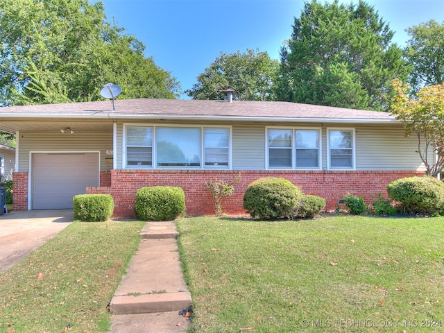 single story home featuring a garage and a front lawn