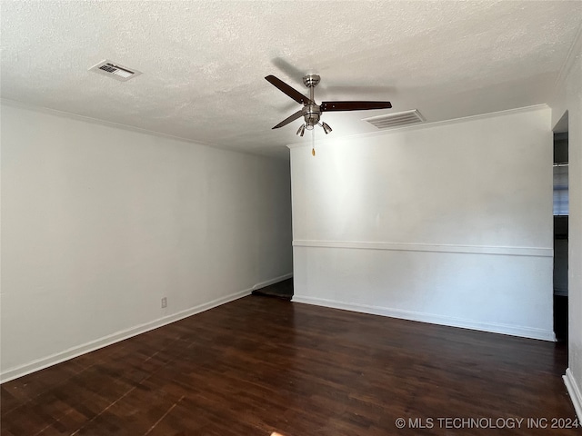 empty room featuring a textured ceiling, dark wood-type flooring, and ceiling fan