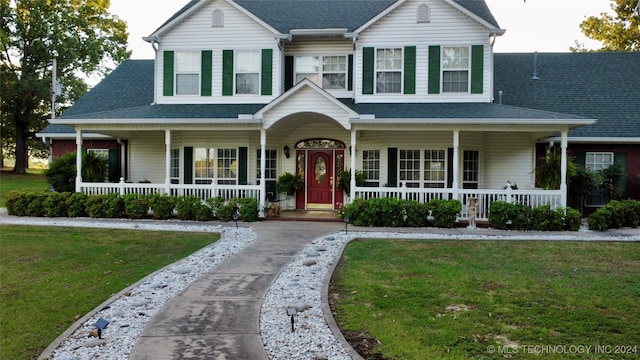 view of front facade with a front lawn and a porch