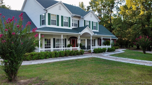 view of front of house featuring covered porch and a front yard