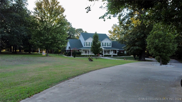 cape cod house featuring a front lawn and a porch