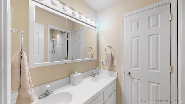 bathroom featuring a shower and vanity