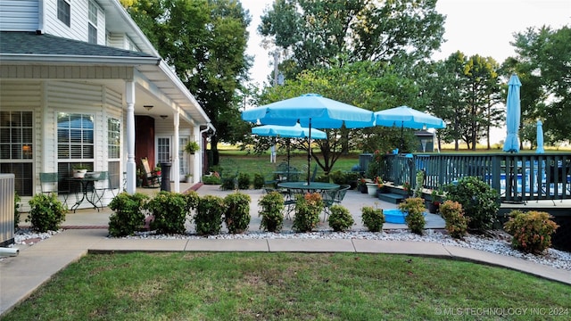 view of yard featuring a patio area and a wooden deck