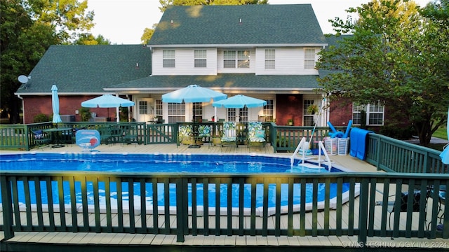 view of swimming pool featuring a deck