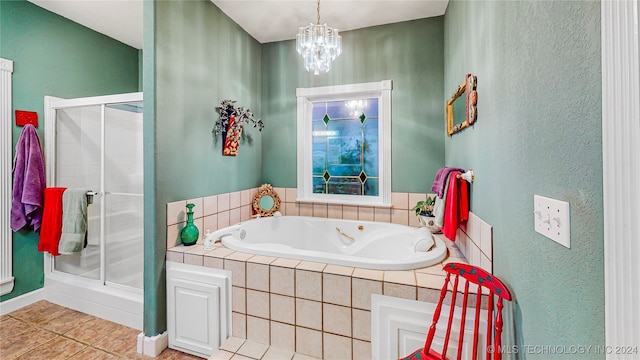 bathroom featuring separate shower and tub, an inviting chandelier, and tile patterned flooring