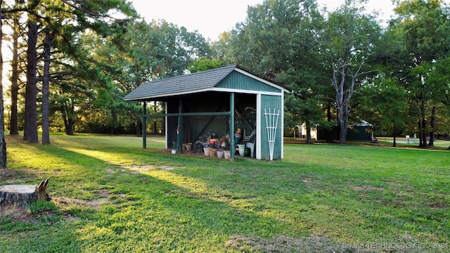 view of outbuilding with a yard