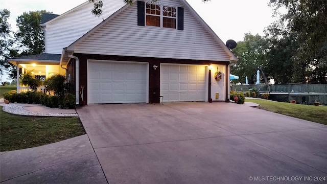 view of side of home with a garage and a yard