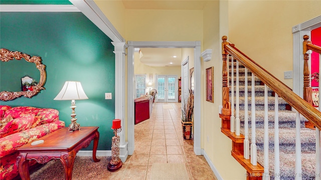 corridor with ornate columns and light tile patterned floors