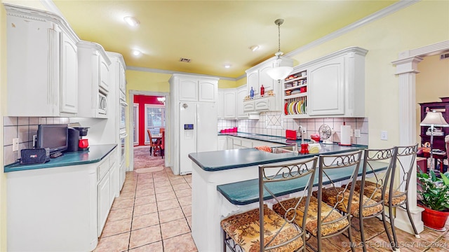 kitchen with white fridge with ice dispenser, ornamental molding, tasteful backsplash, light tile patterned floors, and kitchen peninsula