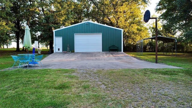 garage featuring a yard and a carport