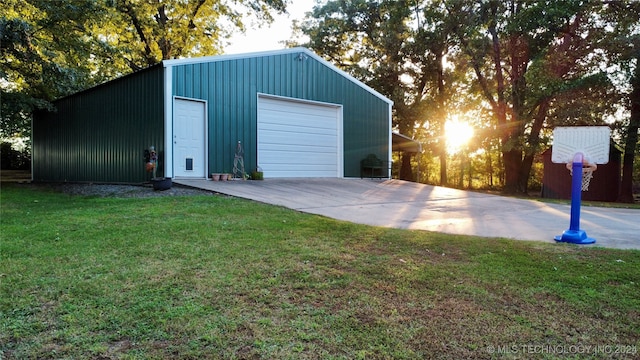 view of outdoor structure featuring a yard and a garage