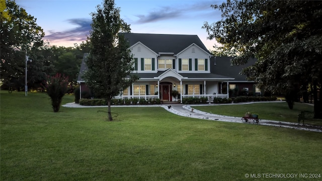 view of front of home featuring a yard and a porch