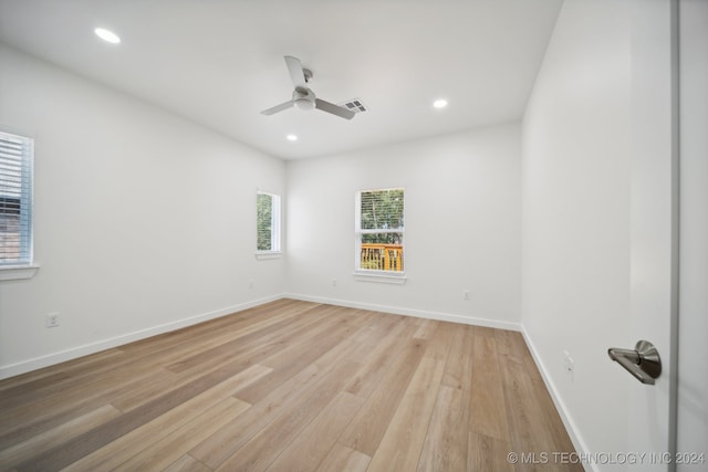 unfurnished room with light wood-type flooring and ceiling fan