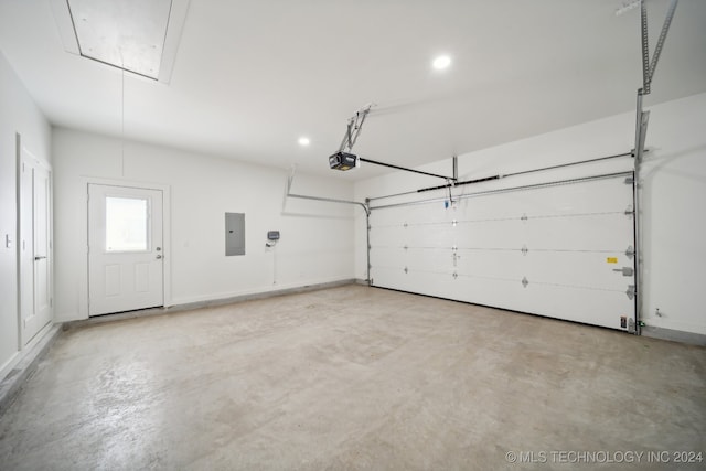 garage with electric panel and a garage door opener