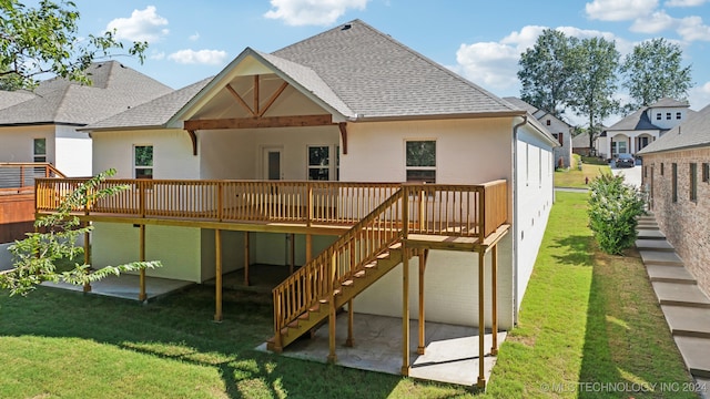 rear view of property with a yard, a patio area, and a wooden deck