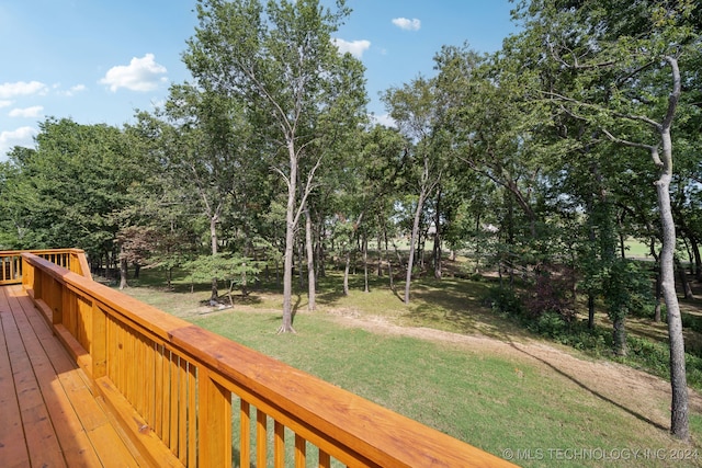 wooden terrace with a lawn