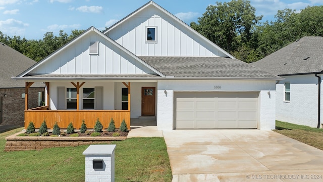 modern farmhouse style home with a garage, a porch, and a front yard