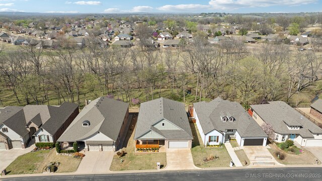 modern farmhouse with a front yard, a garage, and covered porch