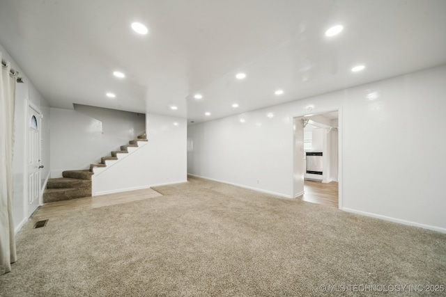 basement featuring light colored carpet