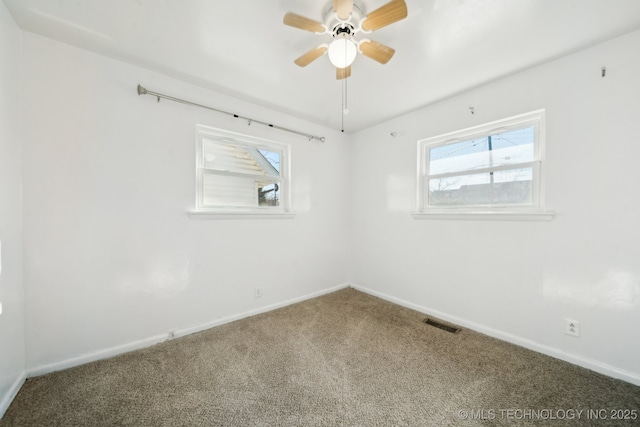 carpeted spare room with ceiling fan