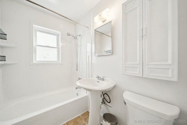 bathroom featuring toilet, tile patterned floors, and shower / bathtub combination