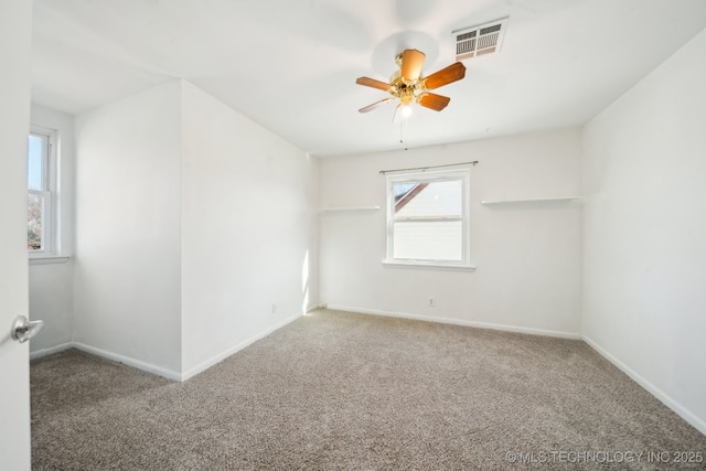 carpeted spare room with ceiling fan