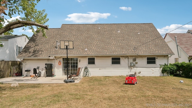 back of property with a patio area and a yard