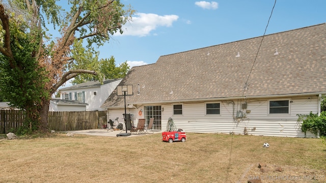 back of property featuring a lawn and a patio area