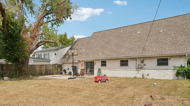 rear view of house featuring a patio and a lawn