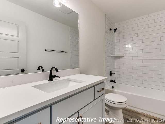 full bathroom with tiled shower / bath combo, vanity, toilet, and wood-type flooring