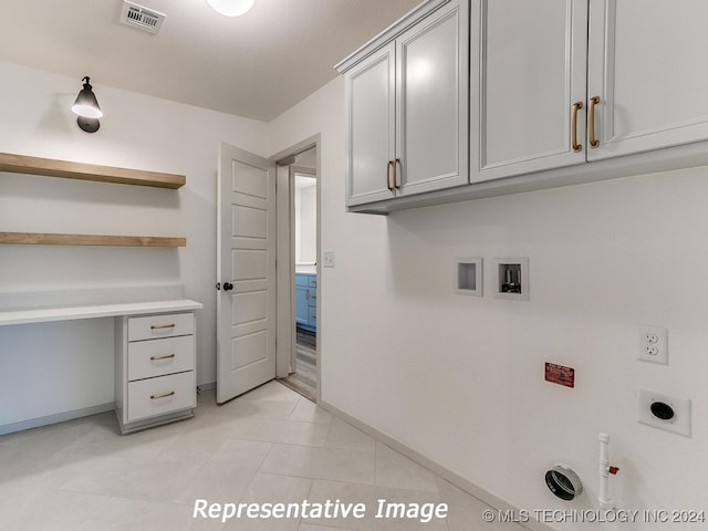 laundry room with cabinets, light tile patterned floors, hookup for an electric dryer, hookup for a gas dryer, and washer hookup