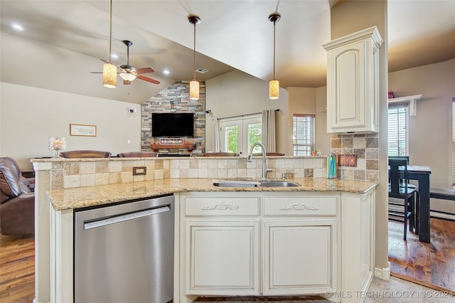 kitchen featuring ceiling fan, sink, light hardwood / wood-style flooring, stainless steel dishwasher, and vaulted ceiling