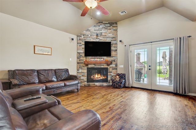 living room featuring hardwood / wood-style floors, french doors, and vaulted ceiling