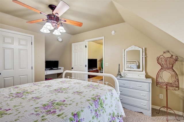 carpeted bedroom featuring ceiling fan, a closet, and lofted ceiling