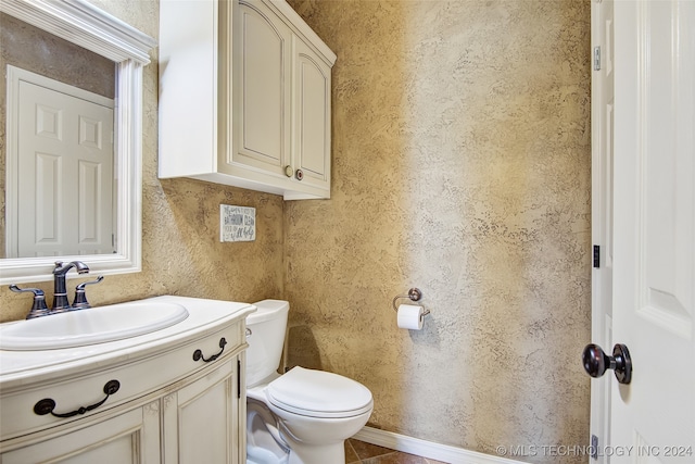 bathroom featuring tile patterned floors, vanity, and toilet