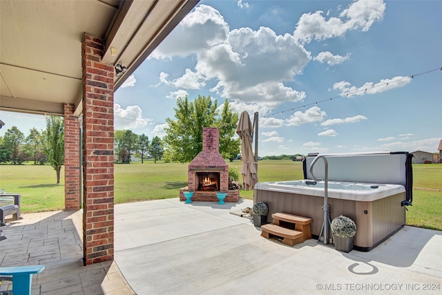 view of patio / terrace with an outdoor brick fireplace and a hot tub