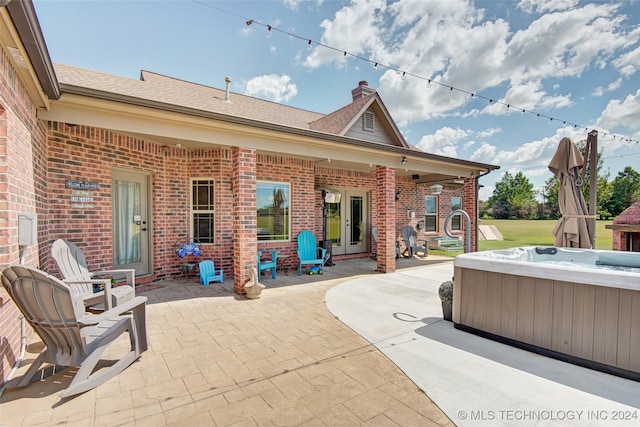 view of patio featuring french doors and a hot tub